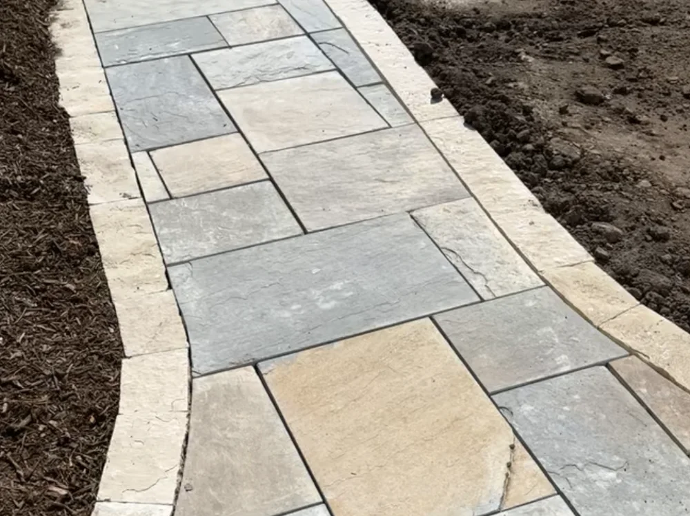 Flagstone pathway set through a planted yard by Larkin Landscape and Design