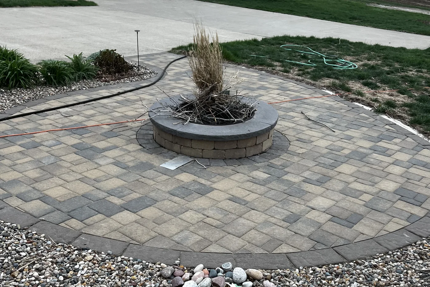Paver patio with a seat wall and outdoor seating, built by Larkin Landscape and Design