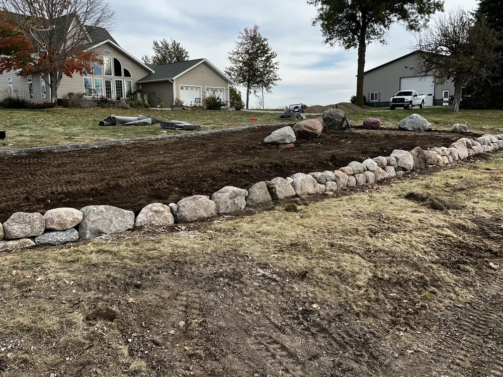 Retaining wall with a planted border by Larkin Landscape and Design